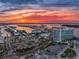 Panoramic aerial view of the condo complex at sunset with a waterway and construction visible at 100 Bayside Dr # 202, Clearwater Beach, FL 33767