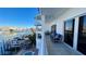 Spacious balcony overlooking the canal with comfortable seating and a ceiling fan at 100 Bayside Dr # 202, Clearwater Beach, FL 33767