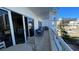 Relaxing balcony with canal views, outdoor seating, and bright sunlight at 100 Bayside Dr # 202, Clearwater Beach, FL 33767