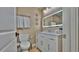 Stylish bathroom featuring a vanity with sink, a toilet and a light up mirror at 100 Bayside Dr # 202, Clearwater Beach, FL 33767