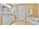 Bathroom boasts a double vanity, bathtub, and a separate toilet room at 100 Bayside Dr # 202, Clearwater Beach, FL 33767