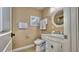 Elegant bathroom with a decorative mirror, white vanity, and tiled floor at 100 Bayside Dr # 202, Clearwater Beach, FL 33767