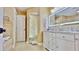 Modern bathroom with double vanity, tub, and glass-enclosed shower at 100 Bayside Dr # 202, Clearwater Beach, FL 33767