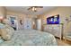 Cozy bedroom featuring a queen-size bed, dresser with TV, and closet at 100 Bayside Dr # 202, Clearwater Beach, FL 33767