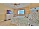Comfortable bedroom with a queen-size bed, dresser with TV and great view at 100 Bayside Dr # 202, Clearwater Beach, FL 33767