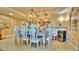 Bright dining room features a chandelier, kitchen views, and beach-themed decor at 100 Bayside Dr # 202, Clearwater Beach, FL 33767