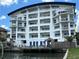 Stunning multi-story waterfront condo with a private dock, tiki huts, and stunning architectural details at 100 Bayside Dr # 202, Clearwater Beach, FL 33767