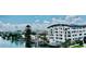 White condo complex with a curved roof and balconies overlooks the water at 100 Bayside Dr # 202, Clearwater Beach, FL 33767