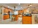 Spacious kitchen featuring wood cabinetry, granite countertops, and modern stainless steel appliances at 100 Bayside Dr # 202, Clearwater Beach, FL 33767
