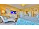 Large main bedroom features a decorative dresser, tv, and a chaise lounge at 100 Bayside Dr # 202, Clearwater Beach, FL 33767