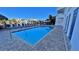 Inviting pool area with lounge chairs, tiki umbrellas, and easy access to the waterfront at 100 Bayside Dr # 202, Clearwater Beach, FL 33767