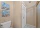Cozy bathroom boasts decorative wall art, a toilet, shower, and neutral paint at 10032 Basin St, New Port Richey, FL 34655