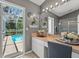 Stylish bathroom with pool view, glass door shower, and modern vanity area at 10032 Basin St, New Port Richey, FL 34655