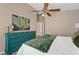 Bright bedroom features fan, plush carpet, and natural light showcasing simple comfort at 10032 Basin St, New Port Richey, FL 34655