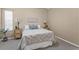 Bedroom featuring a queen bed, side tables with lamps, and neutral decor at 10032 Basin St, New Port Richey, FL 34655