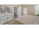 Bedroom featuring a dresser, and a view of the living room at 10032 Basin St, New Port Richey, FL 34655