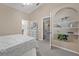 Bright bedroom with built-in shelves, neutral tones and plush carpeting exudes cozy elegance at 10032 Basin St, New Port Richey, FL 34655