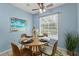 This dining room has a table with 4 chairs, beach themed decorations, and natural lighting at 10032 Basin St, New Port Richey, FL 34655