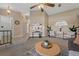 Cozy living room with neutral colors, a ceiling fan, and comfortable seating at 10032 Basin St, New Port Richey, FL 34655
