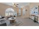 Living room showcasing neutral colors, a ceiling fan, and comfortable seating arrangement at 10032 Basin St, New Port Richey, FL 34655