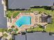 Overhead view showcasing a sparkling pool and lounging area nestled between well-maintained condo buildings at 10195 Sailwinds N Blvd # 208, Largo, FL 33773
