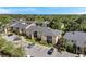 An aerial view of condo community featuring ample parking, lush greenery, and inviting screened in patios at 10195 Sailwinds N Blvd # 208, Largo, FL 33773