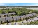 Aerial view showing the community's well-maintained condo buildings, parking areas, and mature trees at 10195 Sailwinds N Blvd # 208, Largo, FL 33773