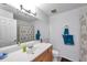 Well-lit bathroom with a large mirror, single sink, and a shower/tub combination at 10195 Sailwinds N Blvd # 208, Largo, FL 33773