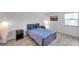 Comfortable bedroom featuring light wood floors, two bedside tables, and a serene atmosphere at 10195 Sailwinds N Blvd # 208, Largo, FL 33773