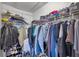 Walk-in closet with an array of clothes, shoes, and storage on shelving at 10195 Sailwinds N Blvd # 208, Largo, FL 33773