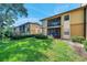 Charming condo exterior featuring well-maintained green spaces and screened-in patios for relaxed outdoor living at 10195 Sailwinds N Blvd # 208, Largo, FL 33773