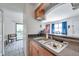 Kitchen sink and breakfast bar offering view of the living room and screened porch at 10195 Sailwinds N Blvd # 208, Largo, FL 33773