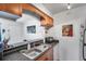 Kitchen sink and countertop featuring wood cabinets, stainless steel sink, and view to adjacent room at 10195 Sailwinds N Blvd # 208, Largo, FL 33773