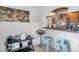 Kitchen bar with barstool seating in an open floor plan offering a view to an adjacent living area at 10195 Sailwinds N Blvd # 208, Largo, FL 33773