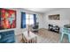 Inviting living room featuring neutral tile floors, vibrant art, comfortable seating, and a modern work space at 10195 Sailwinds N Blvd # 208, Largo, FL 33773