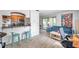 Open-concept living space with bar seating, a comfortable couch, and sliding glass doors to a screened lanai at 10195 Sailwinds N Blvd # 208, Largo, FL 33773