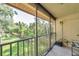 Screened-in patio with view of lush green lawn and mature trees at 10195 Sailwinds N Blvd # 208, Largo, FL 33773