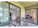 Outdoor patio with seating and a view into the kitchen and living area at 10195 Sailwinds N Blvd # 208, Largo, FL 33773