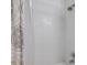 Bathroom shower area featuring white tile, shower head, and neutral shower curtain at 10195 Sailwinds N Blvd # 208, Largo, FL 33773