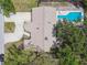 Bird's-eye view of home with sprawling backyard including refreshing pool, and a long driveway at 10265 130Th St, Largo, FL 33774