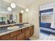 Bathroom featuring double sinks, vanity, and unique blue-tiled shower at 10265 130Th St, Largo, FL 33774