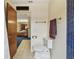 Bright bathroom featuring blue tile accents, neutral walls, and modern fixtures at 10265 130Th St, Largo, FL 33774