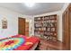 Bright bedroom featuring wood floors, custom built-in bookcase, and ample closet space at 10265 130Th St, Largo, FL 33774