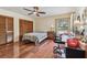 Bedroom with hardwood floors, ceiling fan, and large window for natural light at 10265 130Th St, Largo, FL 33774