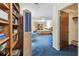 Bright room area leads to the Primary bedroom, featuring built-in storage, and neutral toned decor at 10265 130Th St, Largo, FL 33774