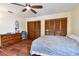 Bedroom featuring wood floors, a ceiling fan, and ample closet space at 10265 130Th St, Largo, FL 33774