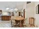 Inviting dining area features a round wood table and neutral chairs, adjacent to the kitchen at 10265 130Th St, Largo, FL 33774