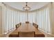 Spacious dining room with a long table set under a vintage chandelier at 10265 130Th St, Largo, FL 33774