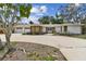Well-maintained one-story home with a two-car garage, and charming landscaping in the daylight at 10265 130Th St, Largo, FL 33774