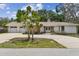 Well-maintained one-story home with a spacious driveway and charming landscaping in the daylight at 10265 130Th St, Largo, FL 33774